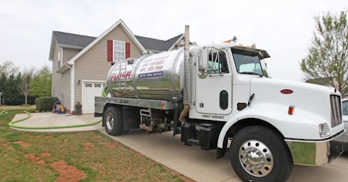 Septic service truck near a home